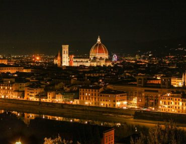 Stunning night view of Florence with Il Duomo and cityscape illuminated against the night sky.