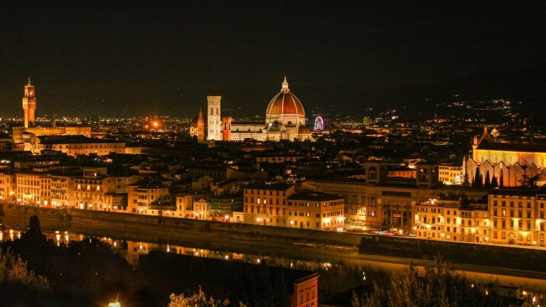 Stunning night view of Florence with Il Duomo and cityscape illuminated against the night sky.